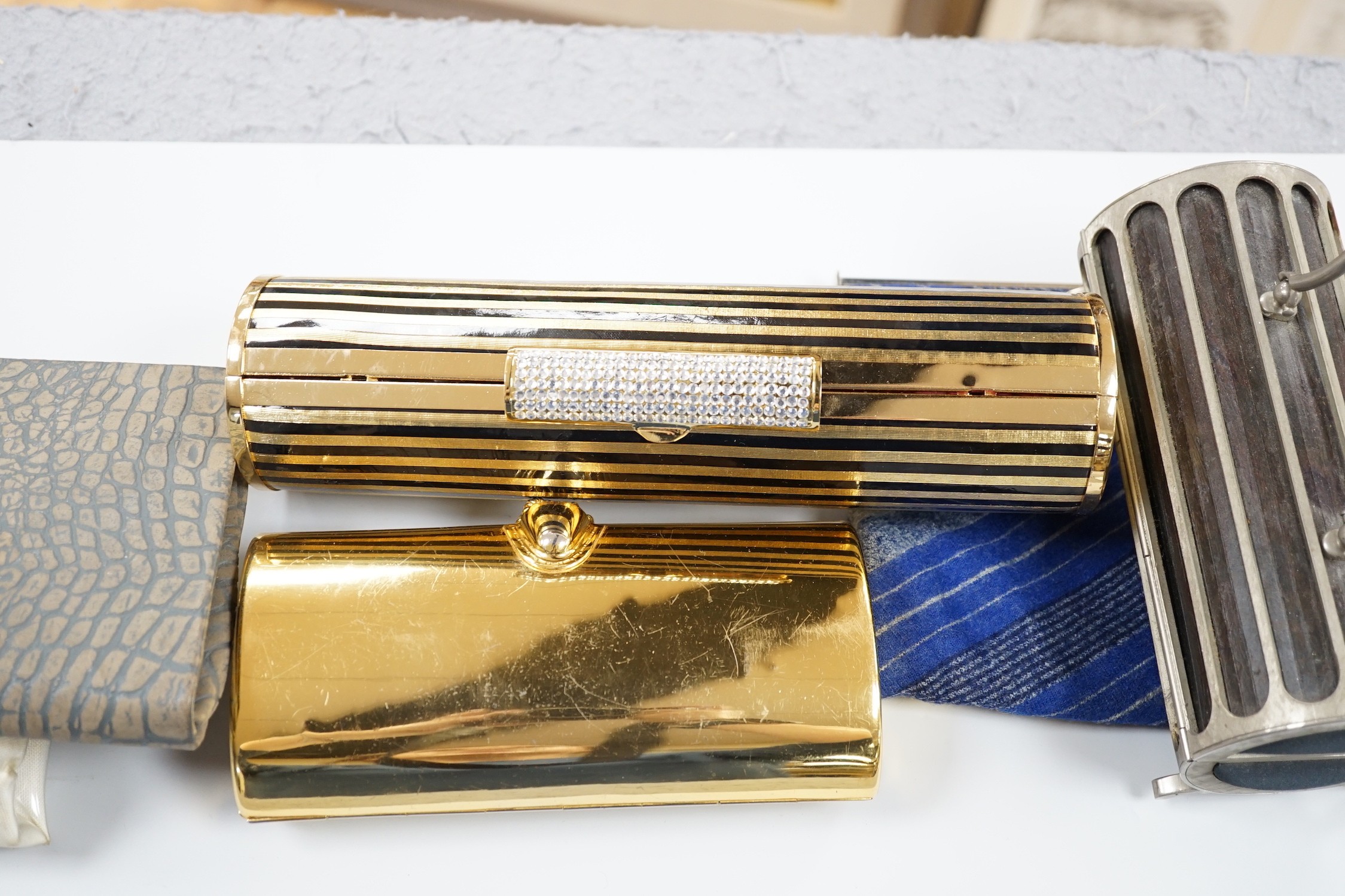 Two 1960's gilt metal ladies evening bags, a metal and wooden bag, a 1950's plastic and fabric bag possibly American, a 1930's faux crocodile clutch bag and a 1930's stripe clutch bag